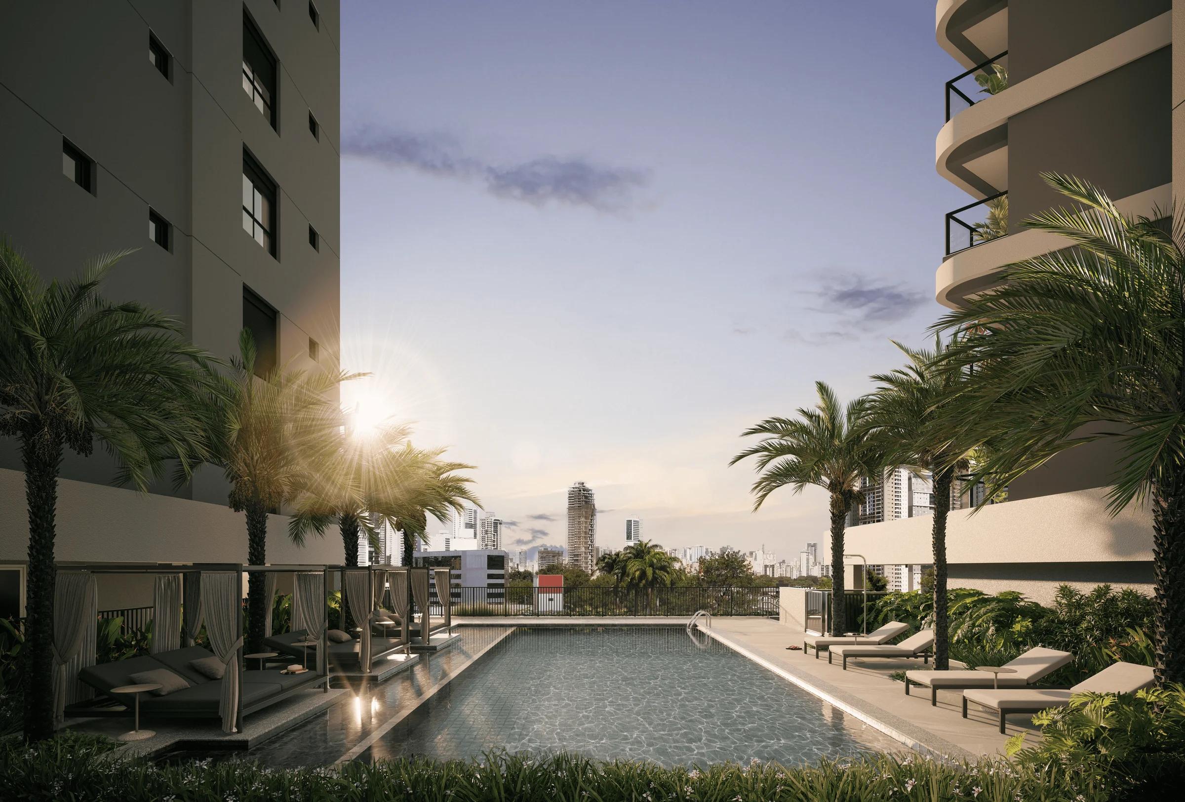 Vista ampla da área da piscina externa com gazebos, espreguiçadeiras e torres residenciais ao fundo