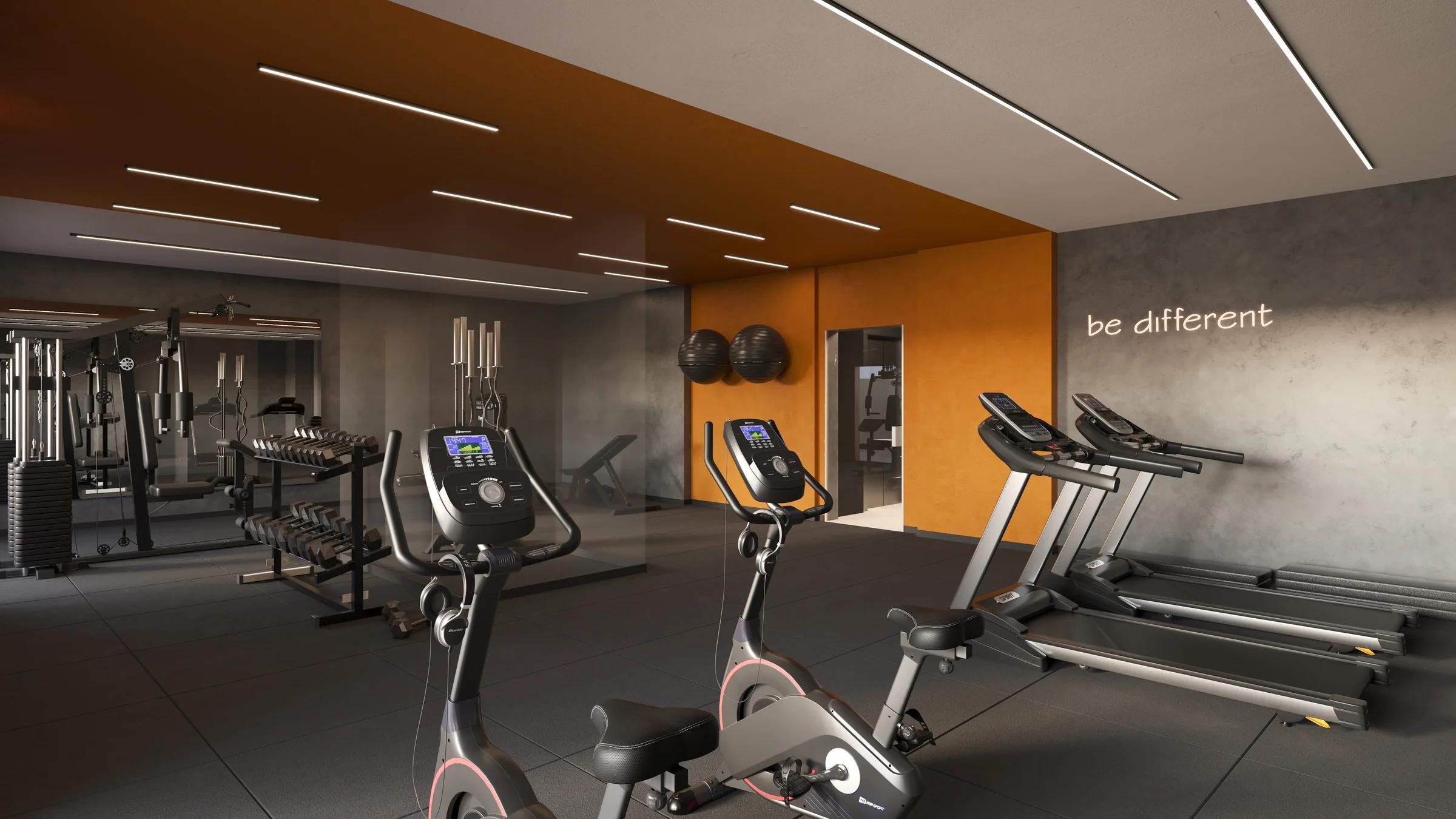 Academia coberta equipada com esteiras, bicicletas ergométricas e aparelhos de musculação