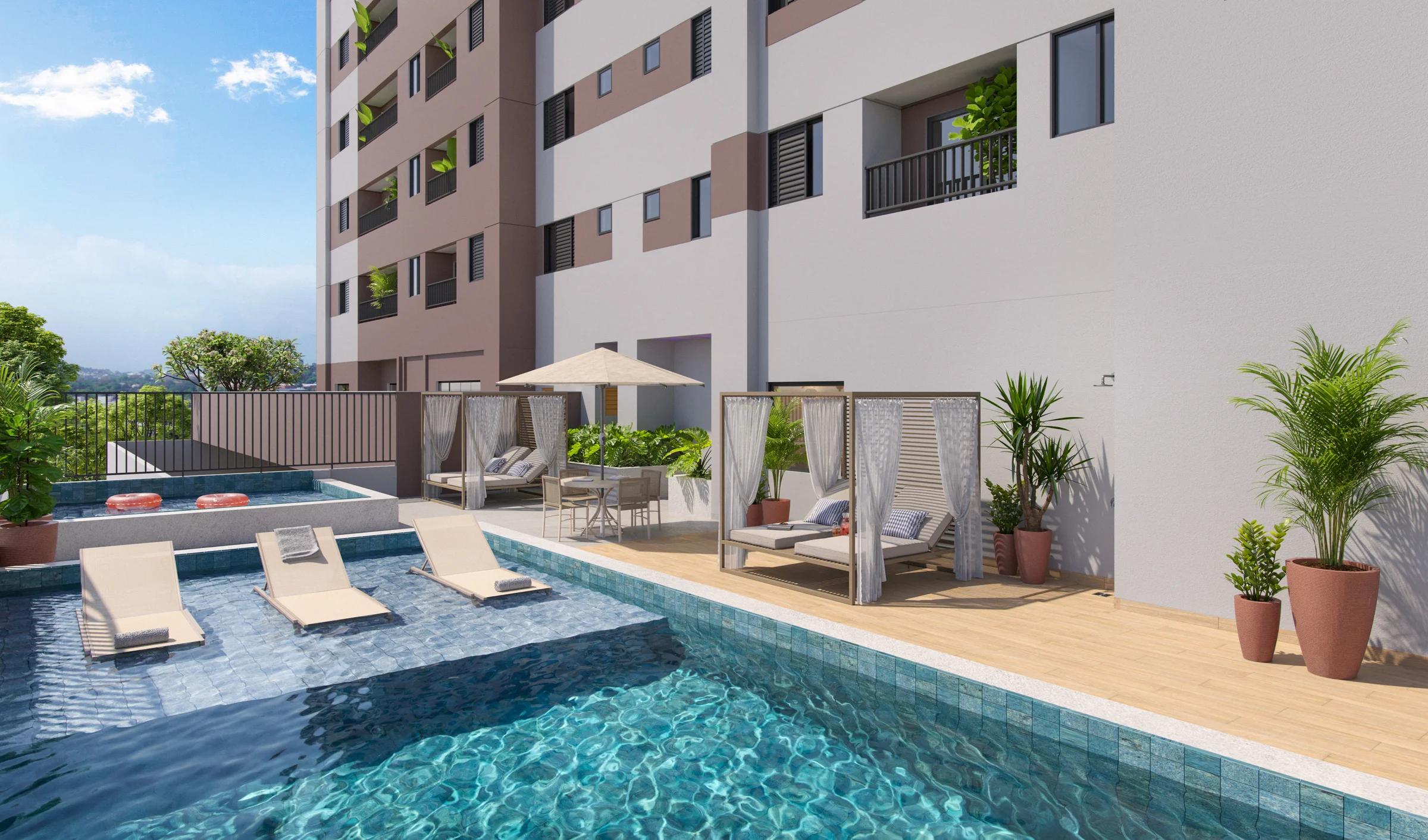 Área da piscina com espreguiçadeiras, cabanas e vista da torre do edifício