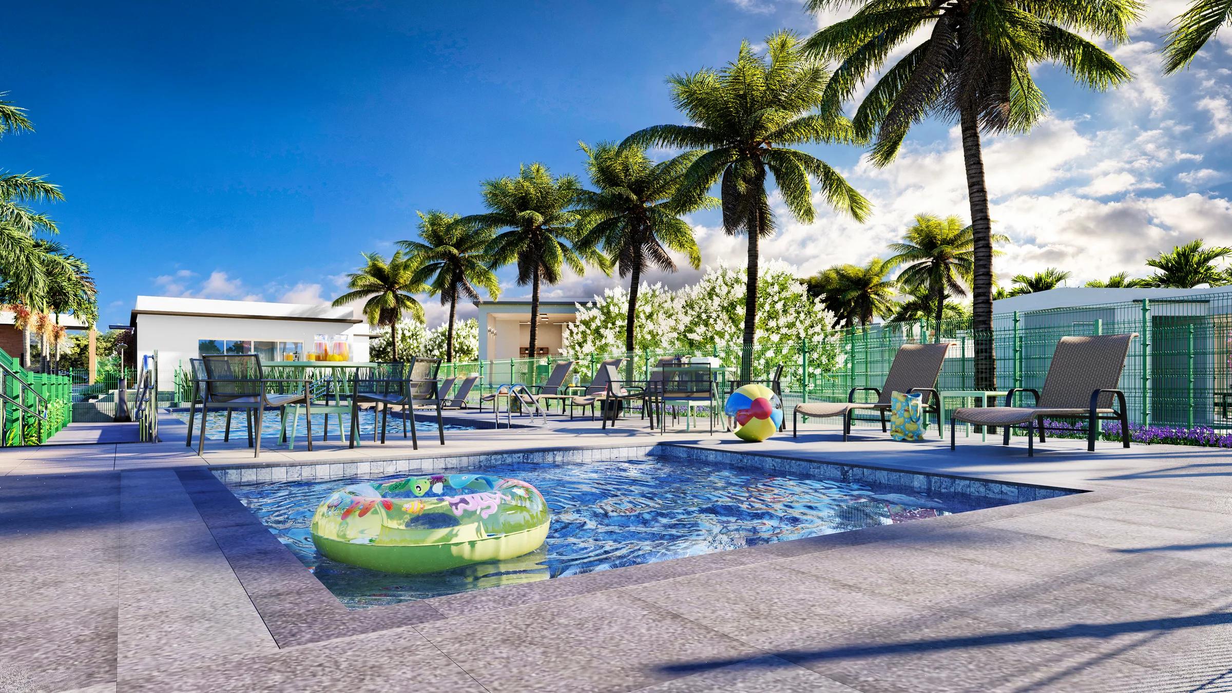 Perspectiva da piscina infantil com mesas e coqueiros ao redor