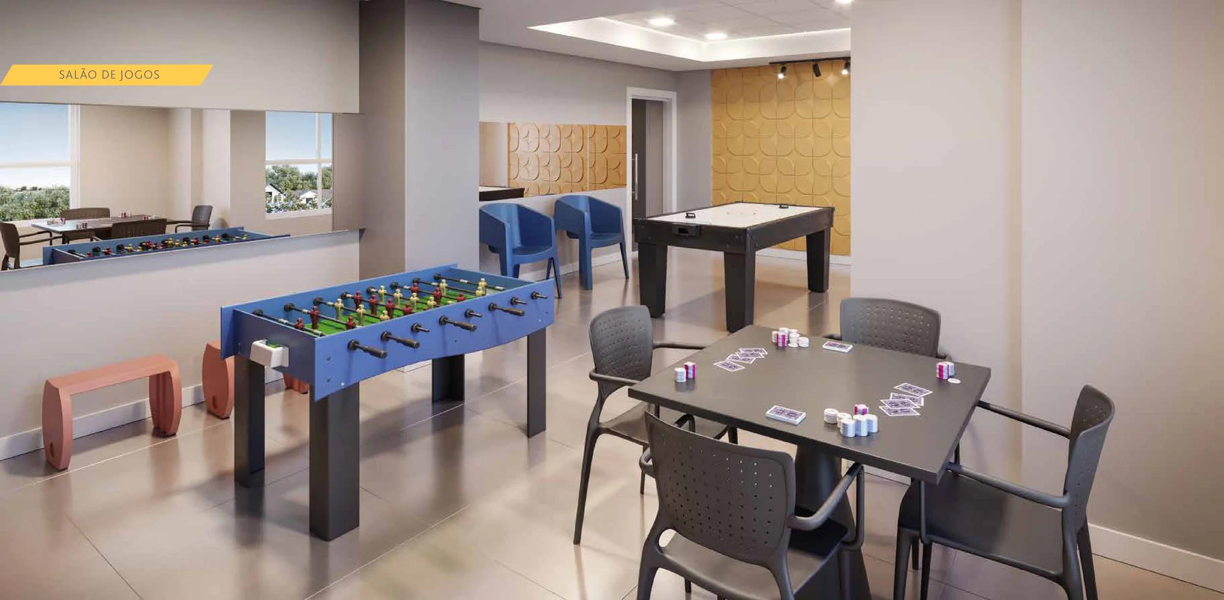 Salão de jogos com mesa de pebolim, mesa de cartas e aero hockey