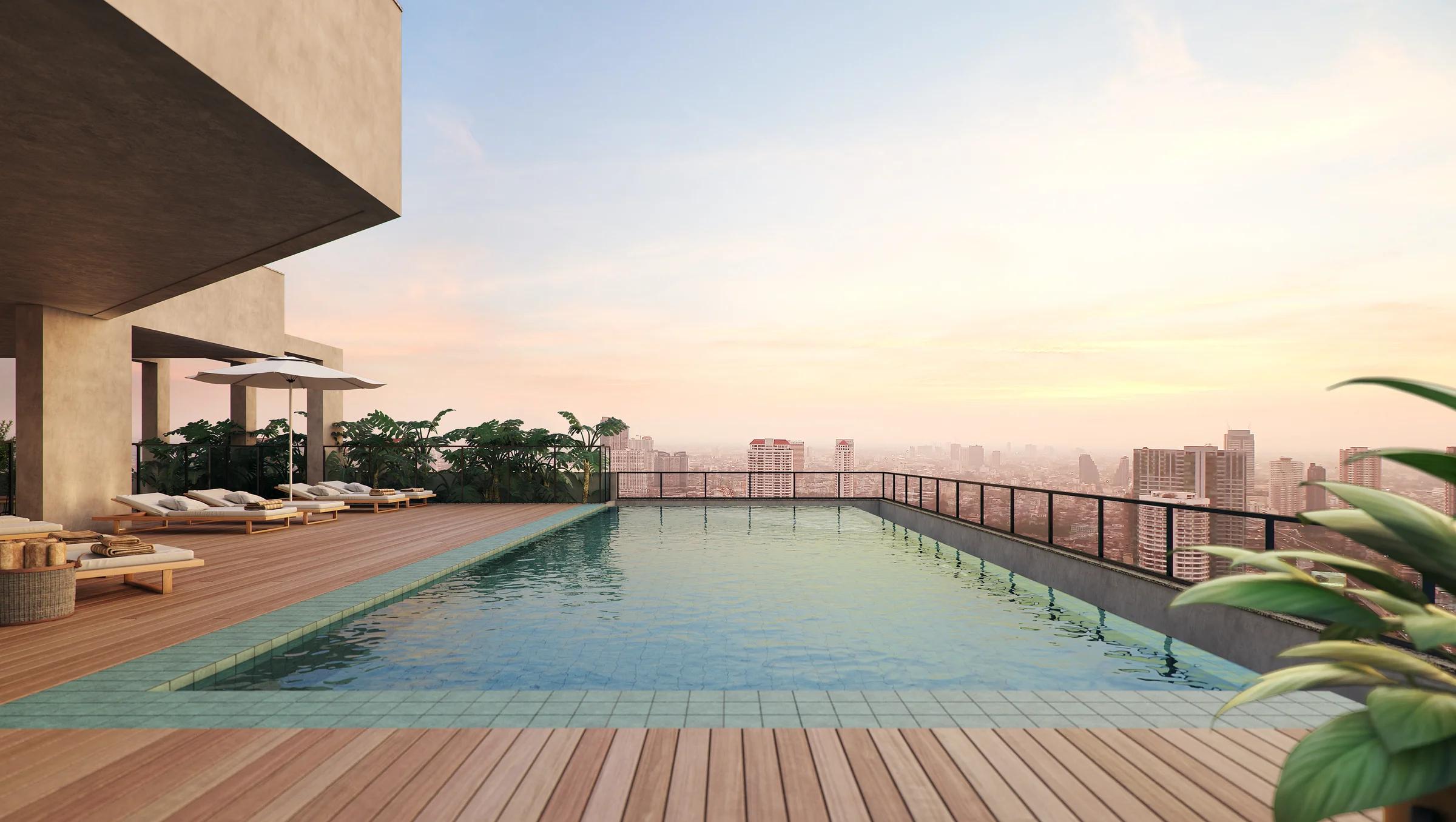 Piscina com borda infinita no rooftop ao entardecer com vista panorâmica da cidade