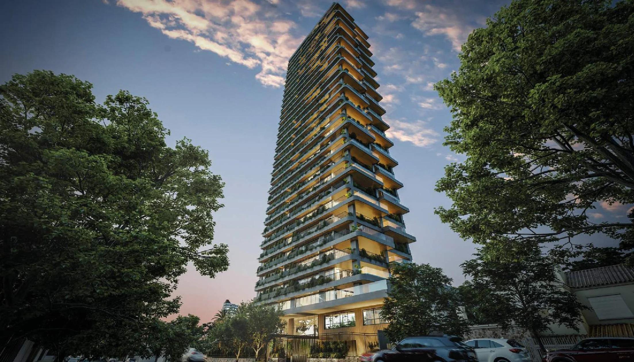 Fachada do edifício vista em perspectiva angular de baixo para cima ao entardecer com iluminação interna
