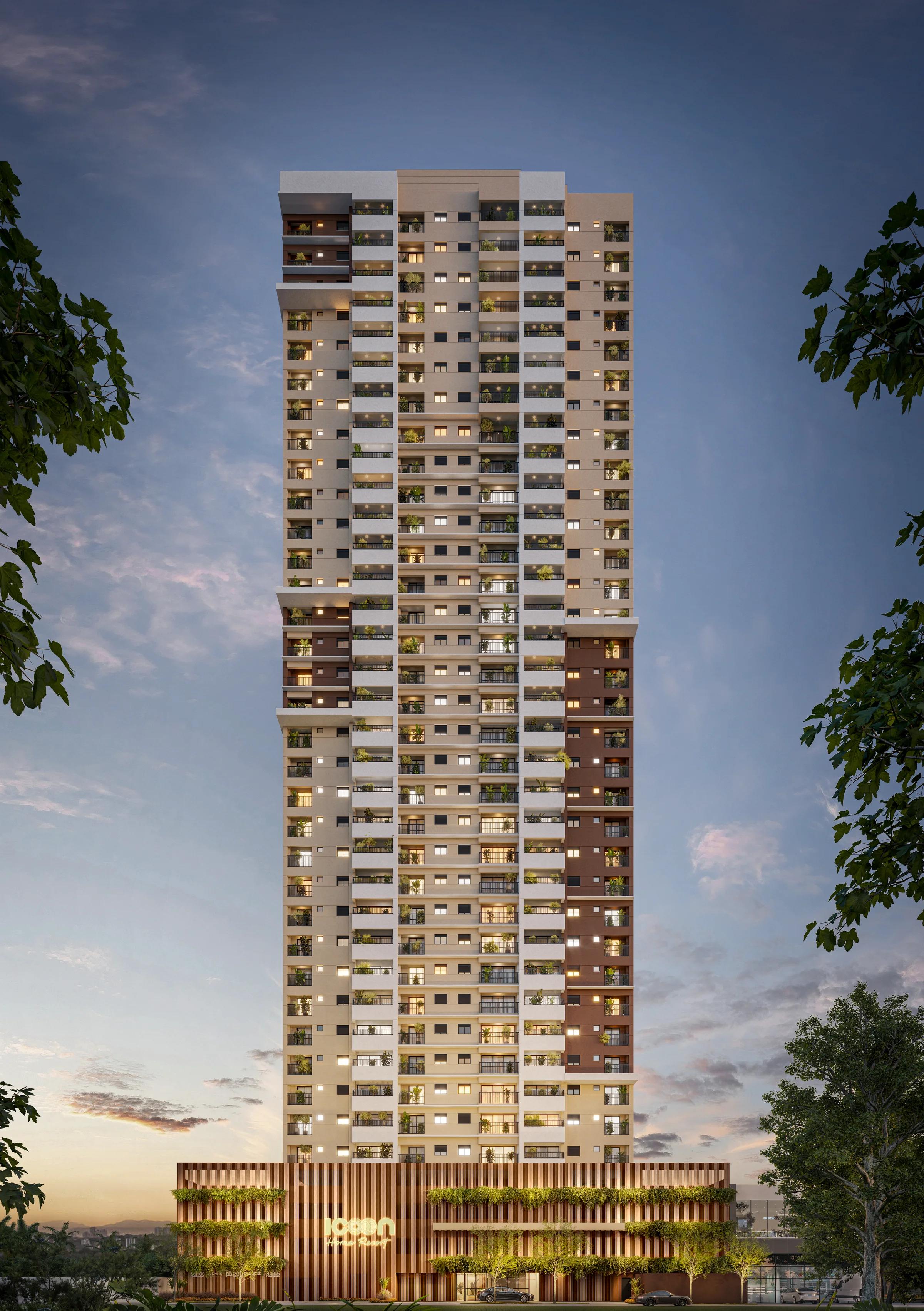 Fachada frontal da torre residencial com base comercial e iluminação ao entardecer